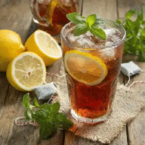 No sugar iced tea recipe with lemon and fresh mint on rustic wooden table