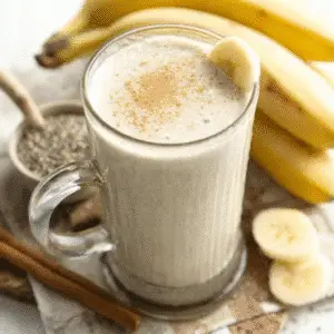 banana smoothie with chia and banana slices on white marble